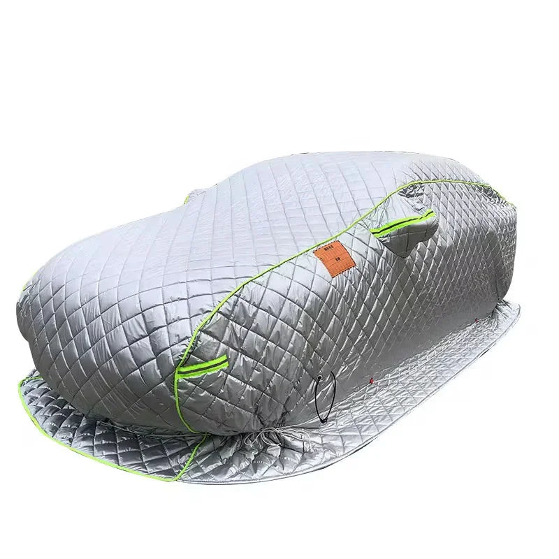 Silver quilted car cover with green trim for hail and weather protection