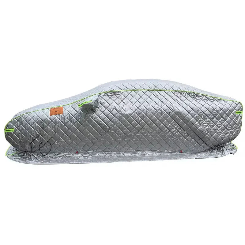 Silver quilted car cover with green trim for hail and weather protection