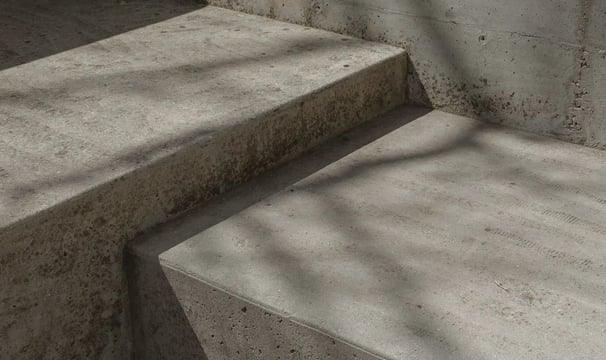 Concrete steps with textured surface and shadow patterns, ideal for durable home exterior protection